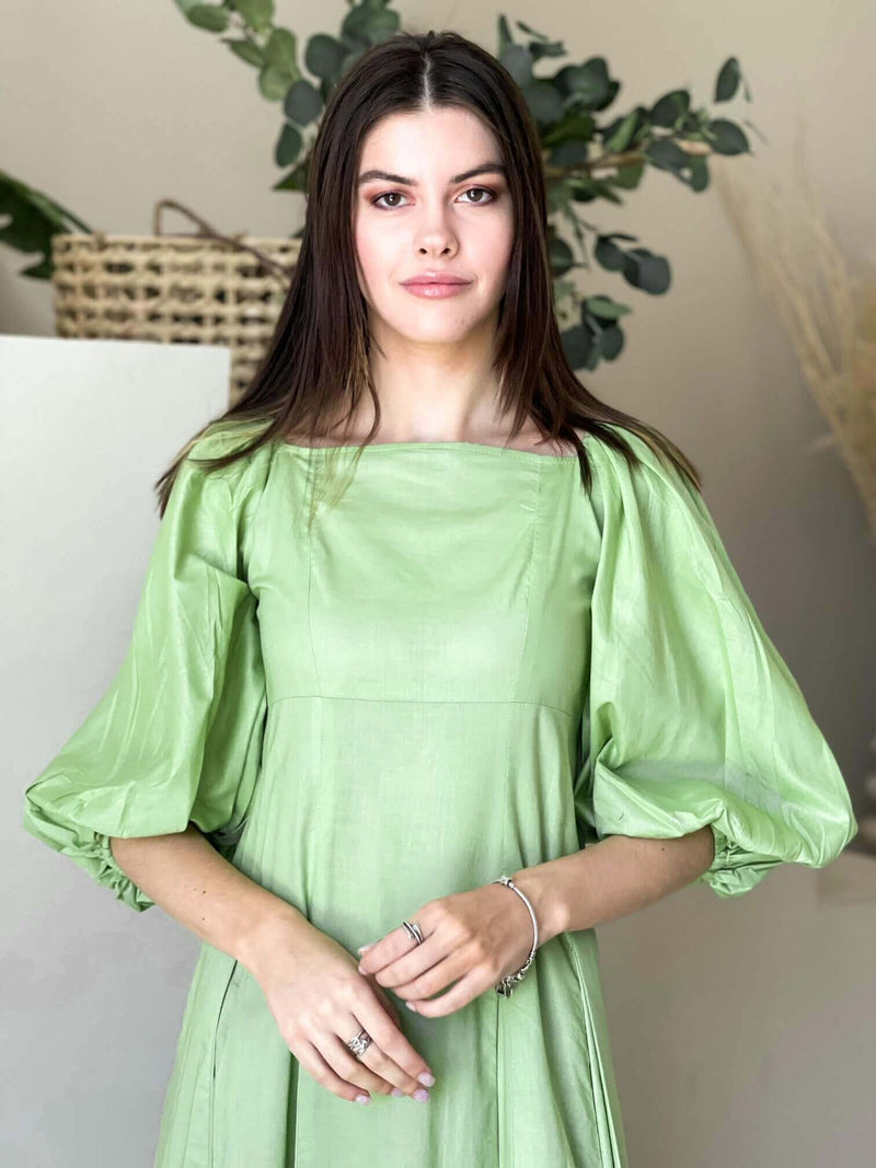 model wearing a pastel green dress by sowears