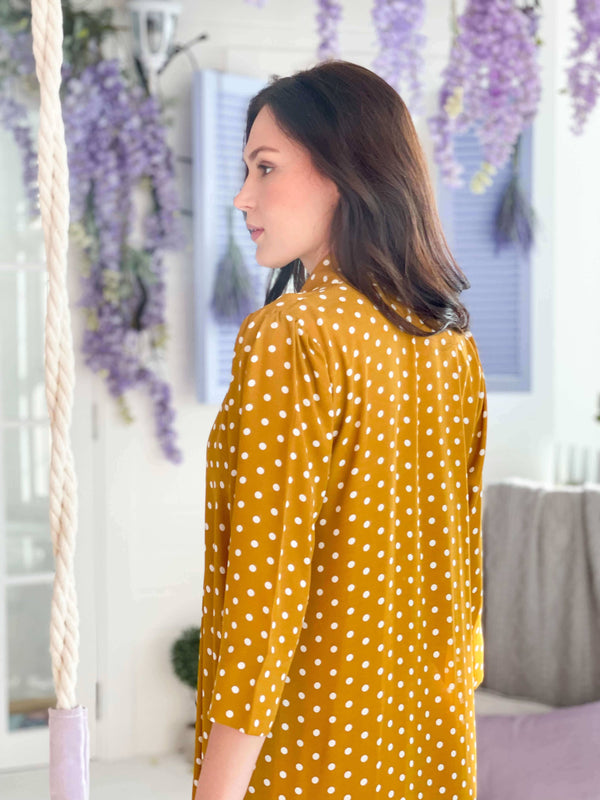 side profile of a model wearing mustard colored polka dot dress by sowears