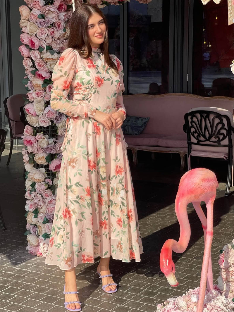 model wearing sowears peach floral dress with long sleeves