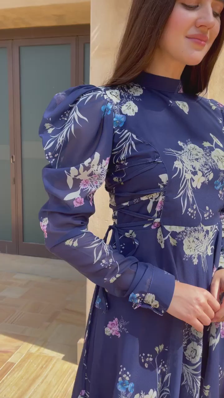 video of a model wearing navy blue floral dress by sowears