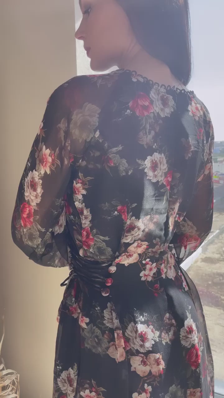 video of a model wearing elizabeth black floral dress by sowears