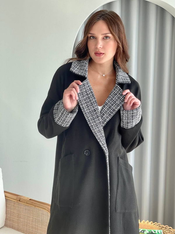 model wearing black drop shoulder women coat