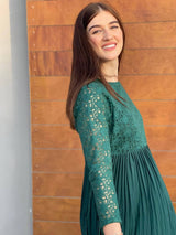 side profile of a model wearing beryl emerald green pleated dress by sowears