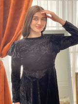 model wearing black velvet maxi dress with sleeves