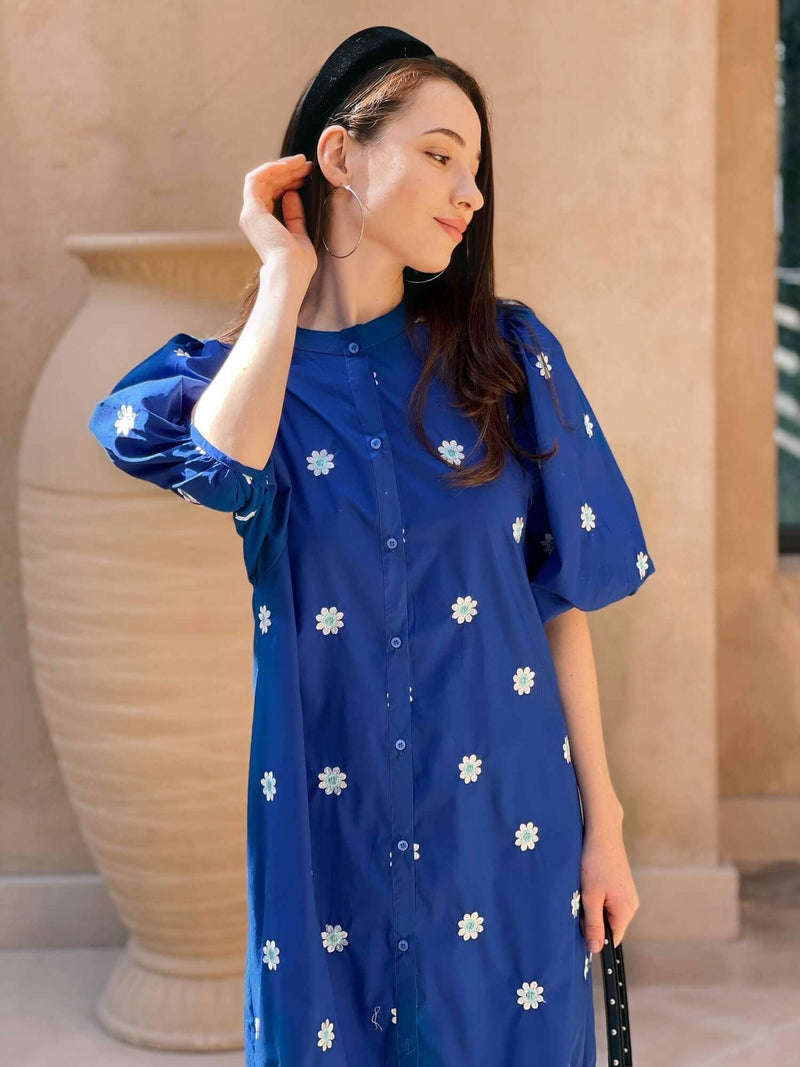 side pose of a model wearing blue embroidered dress by sowears
