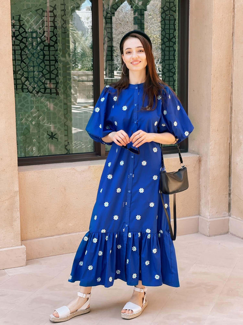 model wearing blue embroidered dress