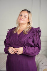 plus size model wearing purple pleated dress