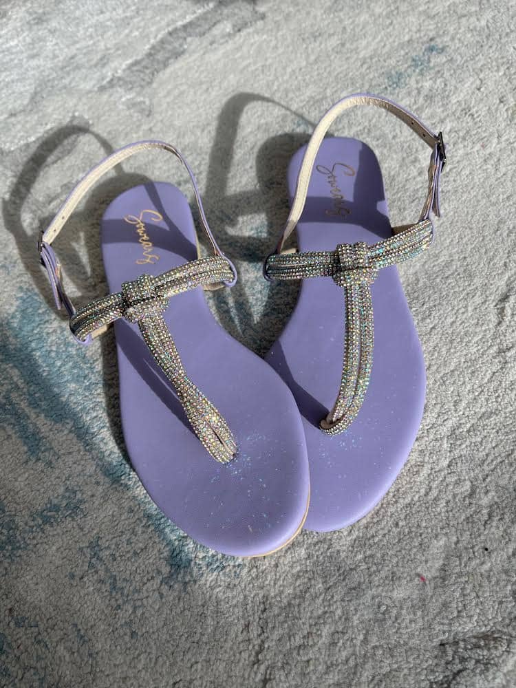purple flat sandals in the sun